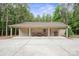 Covered carport featuring a concrete pad and outdoor seating with mature trees at 270 North St, Salisbury, NC 28147