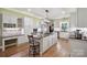Spacious kitchen boasts white cabinets, granite counters, stainless appliances, and a large center island at 270 North St, Salisbury, NC 28147