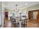 Bright eat-in kitchen featuring a large center island, stainless appliances, and a view to the entry at 270 North St, Salisbury, NC 28147
