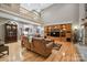 Open-concept living room with a wooden entertainment center, hardwood floors, and a view of the second-floor balcony at 270 North St, Salisbury, NC 28147