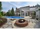 Backyard pool area featuring an outdoor kitchen area and a fire pit at 2812 Julian Glen Cir, Waxhaw, NC 28173