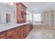Bright bathroom featuring dual vanity sinks, custom cabinets, a walk-in shower, and soaking tub at 2812 Julian Glen Cir, Waxhaw, NC 28173