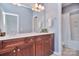 Bathroom featuring double sinks, custom cabinets, and an enclosed shower with a tub at 2812 Julian Glen Cir, Waxhaw, NC 28173