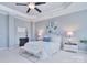 Comfortable bedroom featuring a ceiling fan and tray ceiling, with lots of natural light at 2812 Julian Glen Cir, Waxhaw, NC 28173