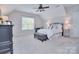 Bright bedroom with a sloped ceiling featuring a double bed, writing desk, and a nightstand at 2812 Julian Glen Cir, Waxhaw, NC 28173
