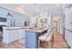 Open concept kitchen with stainless appliances, island with seating, and granite counters provides cooking and entertaining space at 2812 Julian Glen Cir, Waxhaw, NC 28173