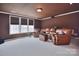 Spacious recreation room featuring a leather sectional couch and bright natural light at 2812 Julian Glen Cir, Waxhaw, NC 28173