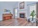 Cozy living room with a brick fireplace, piano, and ample natural light at 2812 Julian Glen Cir, Waxhaw, NC 28173