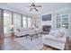 Bright living room featuring a fireplace, built-in shelving, and large windows for plenty of natural light at 2812 Julian Glen Cir, Waxhaw, NC 28173