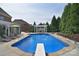 Large pool with diving board, surrounded by patio and lush landscaping at 2812 Julian Glen Cir, Waxhaw, NC 28173