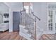 Carpeted staircase with wooden and wrought iron railings leading to the upper level of the home at 2812 Julian Glen Cir, Waxhaw, NC 28173