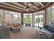 Cozy sunroom with wood ceilings and exposed beams, leading to an outdoor space at 2812 Julian Glen Cir, Waxhaw, NC 28173