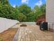 Backyard patio features a white fence, mature trees, and a fire pit by the in-ground pool at 3038 Sterling Ct, Fort Mill, SC 29707