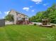 Spacious backyard features an outdoor kitchen, inground pool, tiki bar, mature trees, and lush lawn for ultimate privacy at 3038 Sterling Ct, Fort Mill, SC 29707