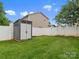 Fenced backyard with lush lawn and storage shed offers privacy and space for outdoor activities at 3038 Sterling Ct, Fort Mill, SC 29707