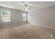 Spacious bedroom featuring neutral colors, a ceiling fan, and natural light from the windows at 3038 Sterling Ct, Fort Mill, SC 29707