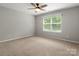 Cozy bedroom with neutral walls, carpet flooring, a ceiling fan, and a bright window view at 3038 Sterling Ct, Fort Mill, SC 29707