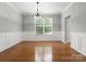 Formal dining room features hardwood floors, wainscoting, and a modern chandelier at 3038 Sterling Ct, Fort Mill, SC 29707