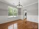 Dining room with hardwood floors, wainscoting, natural light and open access to kitchen at 3038 Sterling Ct, Fort Mill, SC 29707