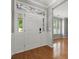 Elegant foyer with hardwood floors, decorative transom window, and white trim detailing at 3038 Sterling Ct, Fort Mill, SC 29707