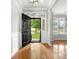 Bright foyer with hardwood floors, decorative transom window, and view into the front yard at 3038 Sterling Ct, Fort Mill, SC 29707