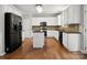 Bright kitchen with black stainless-steel appliances, light cabinets, and hardwood flooring at 3038 Sterling Ct, Fort Mill, SC 29707