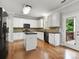 This kitchen features white cabinets, stainless steel appliances, and a black countertop island at 3038 Sterling Ct, Fort Mill, SC 29707