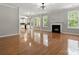 Spacious living room featuring hardwood floors and a cozy fireplace, bathed in natural light at 3038 Sterling Ct, Fort Mill, SC 29707