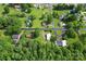 An aerial view of a quiet neighborhood featuring a home with mature trees and lush green lawns at 320 E Pine St, Maiden, NC 28650