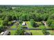 An aerial view of a well-maintained white home with mature trees and an approximate lot line in blue at 320 E Pine St, Maiden, NC 28650