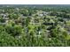 A bird's eye view of a white home in a neighborhood setting with mature trees and green lawns at 320 E Pine St, Maiden, NC 28650