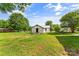 Backyard with lush green grass, blue skies, and trees at 320 E Pine St, Maiden, NC 28650