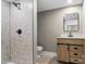 Stylish bathroom featuring a tiled shower, wood-look vanity, and modern fixtures at 320 E Pine St, Maiden, NC 28650