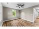 Bright bedroom featuring new hardwood floors, neutral paint and a ceiling fan at 320 E Pine St, Maiden, NC 28650