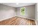 Bright bedroom with new hardwood floors, neutral paint, white trim and natural lighting at 320 E Pine St, Maiden, NC 28650