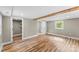 Bright bedroom featuring hardwood-style floors, closet, natural light, and an exposed beam at 320 E Pine St, Maiden, NC 28650