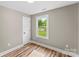 Bedroom featuring hardwood floors, neutral wall color, and door to hallway at 320 E Pine St, Maiden, NC 28650