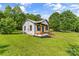 Charming bungalow with a wooden front porch, black shutters, white siding, and a lush green lawn at 320 E Pine St, Maiden, NC 28650