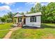 Inviting view of the home's entrance, landscaping and manicured lawn with front porch at 320 E Pine St, Maiden, NC 28650