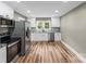 Spacious kitchen with stainless steel appliances, white cabinets, and luxury vinyl plank flooring at 320 E Pine St, Maiden, NC 28650