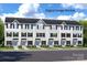 Inviting townhouse exterior with white siding, black shutters, and well-maintained landscaping at 3233 Dannelly Towns Aly # 1002C, Charlotte, NC 28208