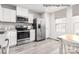 Well-equipped kitchen with stainless steel appliances, white cabinets, and durable countertops at 3233 Dannelly Towns Aly # 1002C, Charlotte, NC 28208