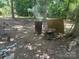 Outside wooded scene shows a barrel burning in the yard at 3234 Legend Rd, Lancaster, SC 29720