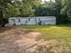 Wide exterior view of a home with lawn and mature trees at 3234 Legend Rd, Lancaster, SC 29720