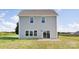 Back exterior of a gray two-story home with a small patio and grassy lawn at 32562-B Millingport Rd # 7155, New London, NC 28127