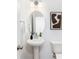 Cozy powder room featuring a pedestal sink, oval mirror, and modern lighting fixtures at 32562-B Millingport Rd # 7155, New London, NC 28127