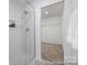 Modern bathroom boasts a glass-enclosed shower and an adjacent walk-in closet for added convenience at 32562-B Millingport Rd # 7155, New London, NC 28127