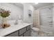 Modern bathroom with gray vanity, neutral tile, and a shower-tub combination at 32562-B Millingport Rd # 7155, New London, NC 28127