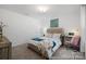 Well-lit bedroom with a cozy bed, a workspace, and a soft color palette for a relaxing atmosphere at 32562-B Millingport Rd # 7155, New London, NC 28127