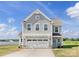 Charming two-story home with gray siding, a two car garage, and a well-manicured lawn at 32562-B Millingport Rd # 7155, New London, NC 28127